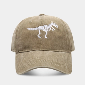 Front detail of khaki washed cotton baseball cap with white dinosaur skeleton embroidery