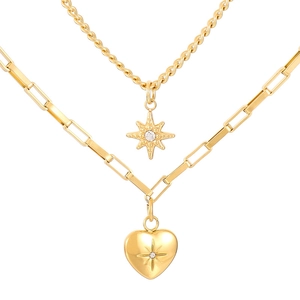 Double-layered gold necklace featuring a starburst and heart pendant on clip chain