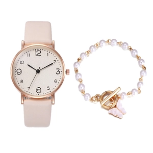 Detail of pink quartz watch and pearl bracelet set with a dainty butterfly pendant