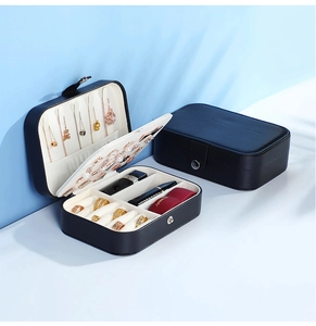Detail view of the open and closed black leather travel jewelry box with interior compartments