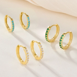 Three pairs of gold hoop earrings set with turquoise, emerald, and clear zircon stones