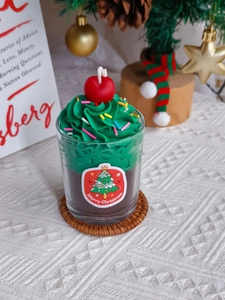 Detail of Christmas strawberry chocolate candle with green cream and merry christmas label