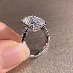 Elegant silver square cut moissanite wedding ring featuring side stone accents on the band