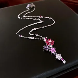 Zircon flower tassel pendant necklace featuring pink and purple gemstones on a thin chain