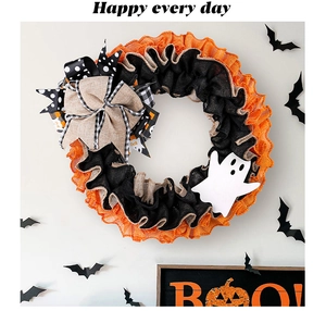 Detailed view of Halloween ghost wreath featuring rustic burlap bows and mesh textures
