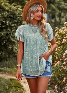Detailed view of women's teal blouse with leopard print and layered ruffle sleeves