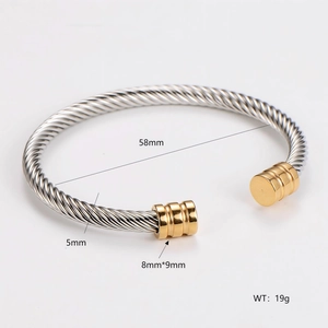 Detail of twisted cable cuff bracelet in two-tone finish with 58mm inner diameter dimensions