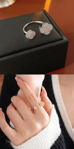Detailed views of double clover open ring in silver and gold with pavé zircon setting