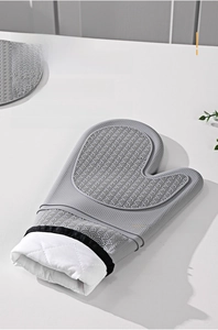 Detail of gray silicone oven mitt showing non-slip fish scale texture and quilted cotton lining
