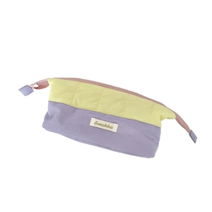 Quilted two-tone storage pouch in yellow and lavender with pink zipper for stationery