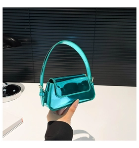 Detail of glossy teal patent leather mini square bag with metallic mirror finish