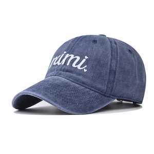 Washed dark blue cotton baseball cap with mimi heart embroidery shown from a 45-degree angle
