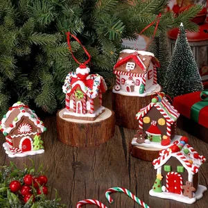 Set of five cute gingerbread house Christmas tree ornaments with snow and red candy details