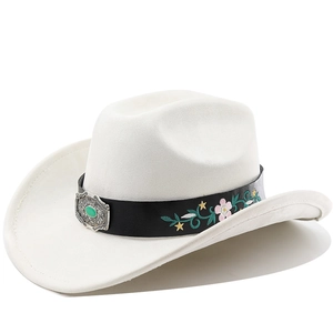 Detail of white felt cowboy hat featuring ethnic floral embroidery and vintage silver buckle