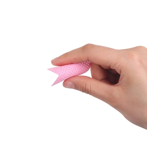 Close-up of pink mesh eyelash glue cleaning pad showing flexible texture and fine holes