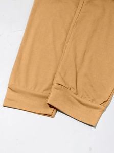 Detail view of khaki joggers featuring high-quality elastic ribbed cuffs and knit fabric