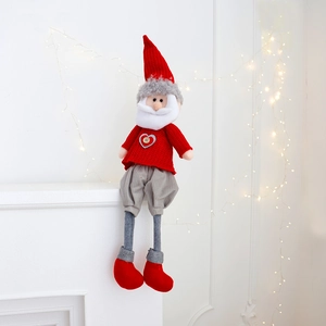 Detail of a handmade Christmas gnome plush with knitted hat and heart wooden button
