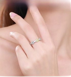 Detail of 925 silver daisy ring with white enamel petals and sparkling crystal accents