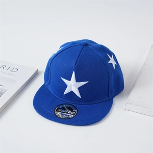 Detailed close-up of blue flat brim cap with white star embroidery and snapback logo