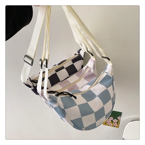Detail of cable knit checkerboard crescent bags in black, lavender and blue colors