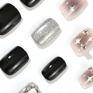 Short black and silver glitter press-on nails with star patterns and rhinestones