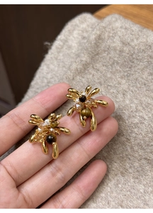 Detailed view of 18K gold plated tiger eye earrings with sparkling crystal accents