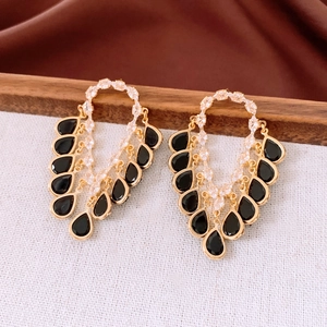 Detail of 18K gold plated earrings with crystal paving and black teardrop pendants