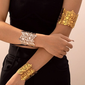 Bracelets ajourés motif fleurs et feuilles en or et argent portés par un mannequin