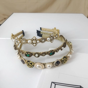 Detail view of baroque pearl headbands with rhinestone and gold wire accents