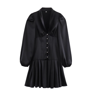 Elegant black satin V-neck mini dress with white buttons and pleated skirt detail