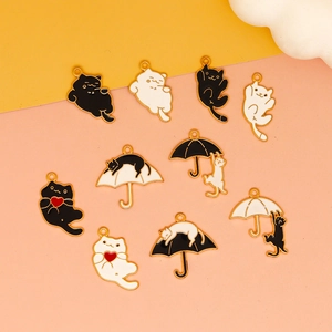 Detailed view of 11 Halloween cat alloy pendants with hearts and umbrellas on a pastel background