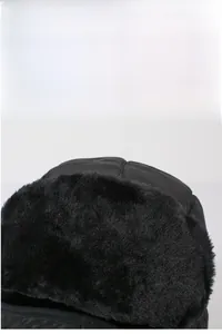 Detail of warm black trapper hat featuring thick faux fur lining and windproof fabric