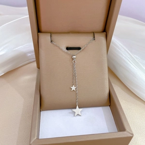 Minimalist titanium steel star tassel necklace displayed in an elegant jewelry gift box