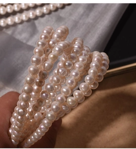 Close-up of 7mm natural freshwater pearls with high luster on silk fabric