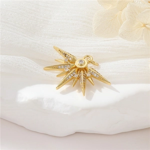 Elegant gold star pendant necklace with small diamonds on white gauze and stone background