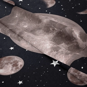Close-up of bohemian moon phase tapestry showing soft velvet texture and star patterns