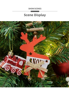 Close-up of red wooden deer ornament with Snow text and mini bell on Christmas tree