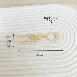 Detail view of U-shaped marble acetate hair pin with 12cm length and 0.4cm thickness