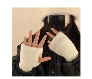 Close-up of white plush fingerless gloves made of soft faux fur for winter warmth