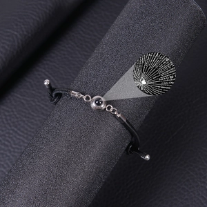 Projection bracelet featuring 100 languages I Love You in silver and black rope cord