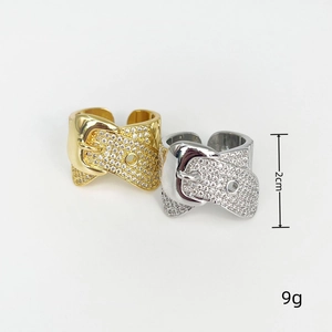Detail of gold and silver buckle rings with rhinestones showing 2cm size and 9g weight