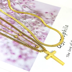 Layered gold titanium steel necklace featuring a cross pendant and sleek snake chain