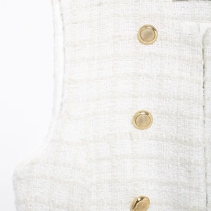 Chic white tweed sleeveless vest with gold embossed buttons and textured woven fabric