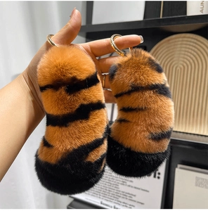 Close-up of soft orange tiger stripe faux fur charms with golden metal key rings