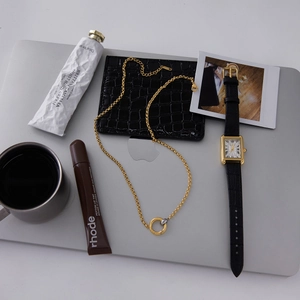 Flat lay of mixed metal heart pendant necklace with stylish luxury daily essentials