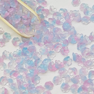 Close-up of pink and blue gradient lily-of-the-valley glass beads for DIY jewelry making