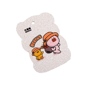 Compressed wood pulp sponge featuring cartoon pink pig and yellow duck pattern