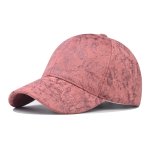 Detailed view of pink tie-dye baseball cap with marble texture and curved brim