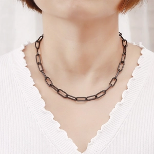 Minimalist stainless steel paperclip link chain necklace worn on neck with V-neck top