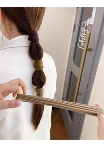 Model wearing elastic seamless hair ties in a ponytail with high stretch material detail